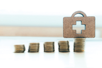 Medical bag on stacks of coins, representing health care costs