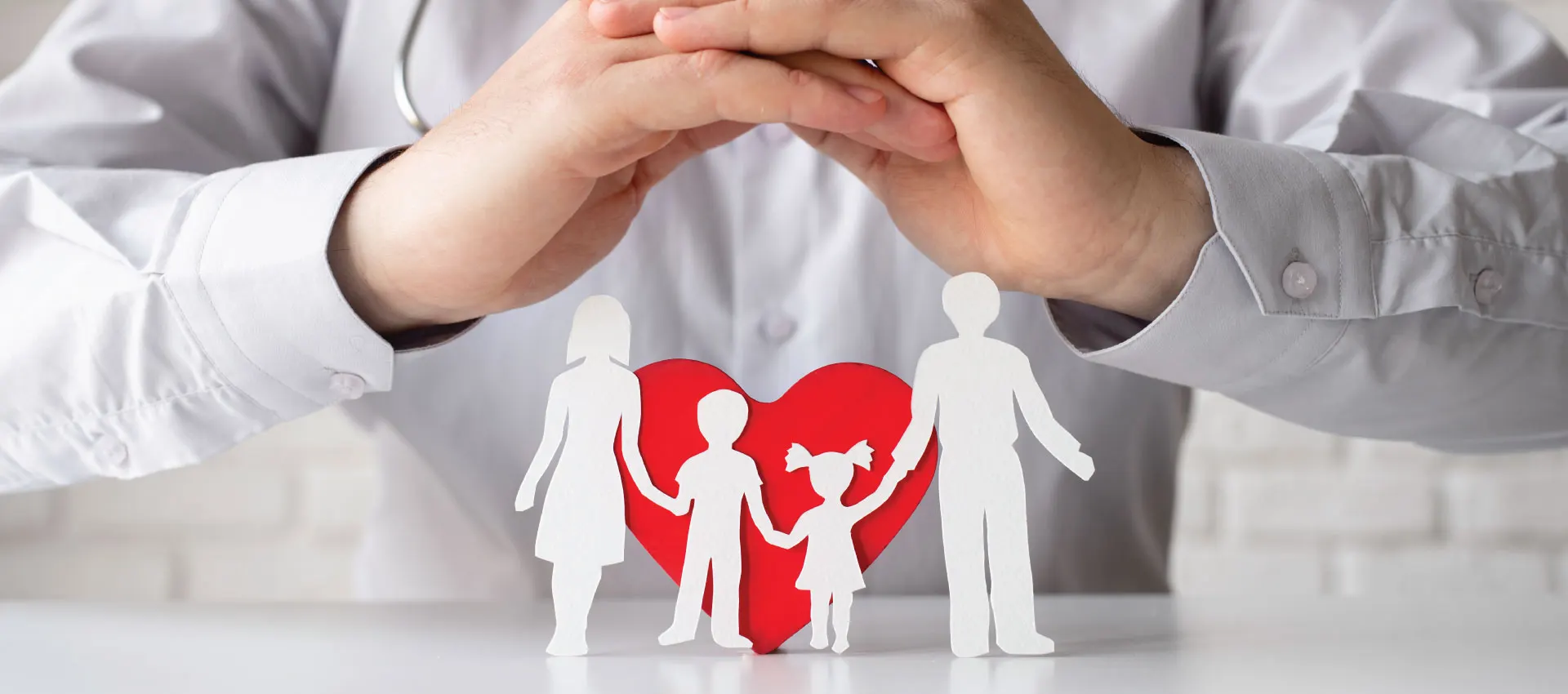 Family protected by caring hands, health insurance for families and small businesses